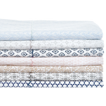 A stack of Ramra Light Indigo Organic Sheets by Sheets & Cases with blue and white organic cotton designs that are machine washable. - 15582948556846