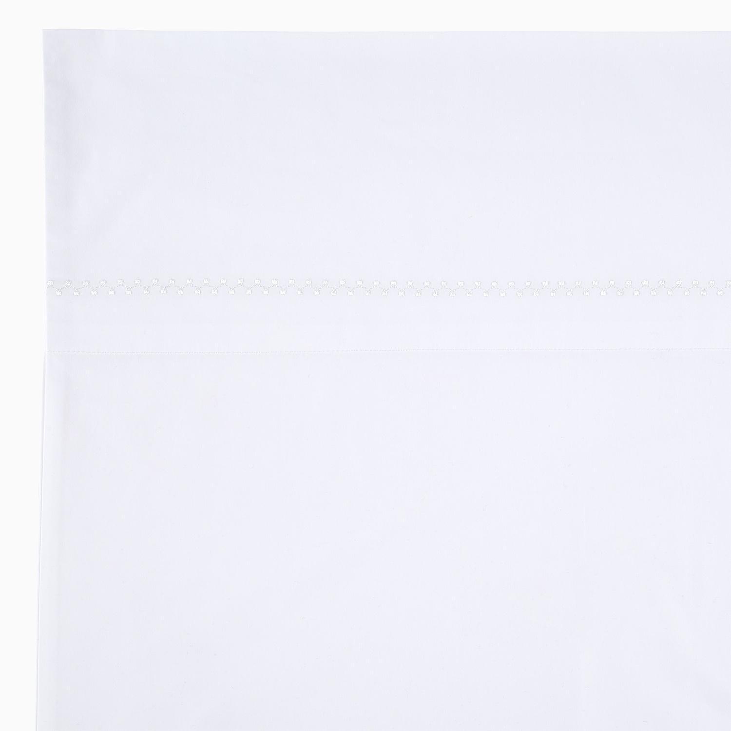 An Anketi White Organic Sheet Set with a white border on it, made from organic cotton percale with long-staple fibers, by John Robshaw.