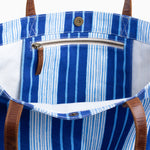 A Vintage Stripe Tote Bag by Decor & More, featuring blue and white stripes and leather handles. - 30253964722222