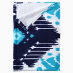 A Sashpura Indigo Beach Towel with an ikat pattern, inspired by Uzbekistan. - 29274367361070