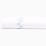 A white sheet with embroidered blue stitching on it would be called the 