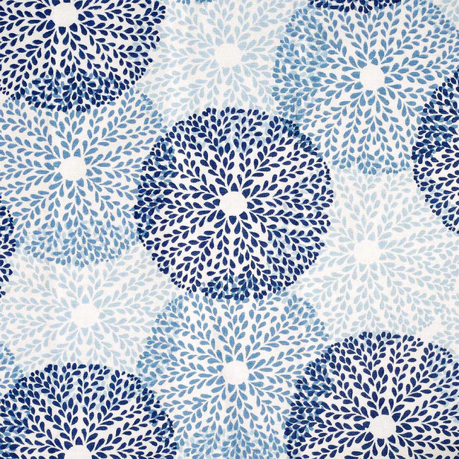 A blue and white floral pattern on a white background featuring artisan craftsmanship, the Chand Lapis Fabric designed by John Robshaw.