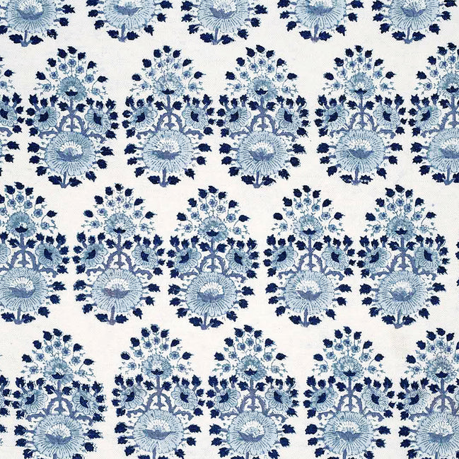A blue and white floral pattern on a white background, created through traditional craftsmanship using Lanka Lapis Fabric by John Robshaw.