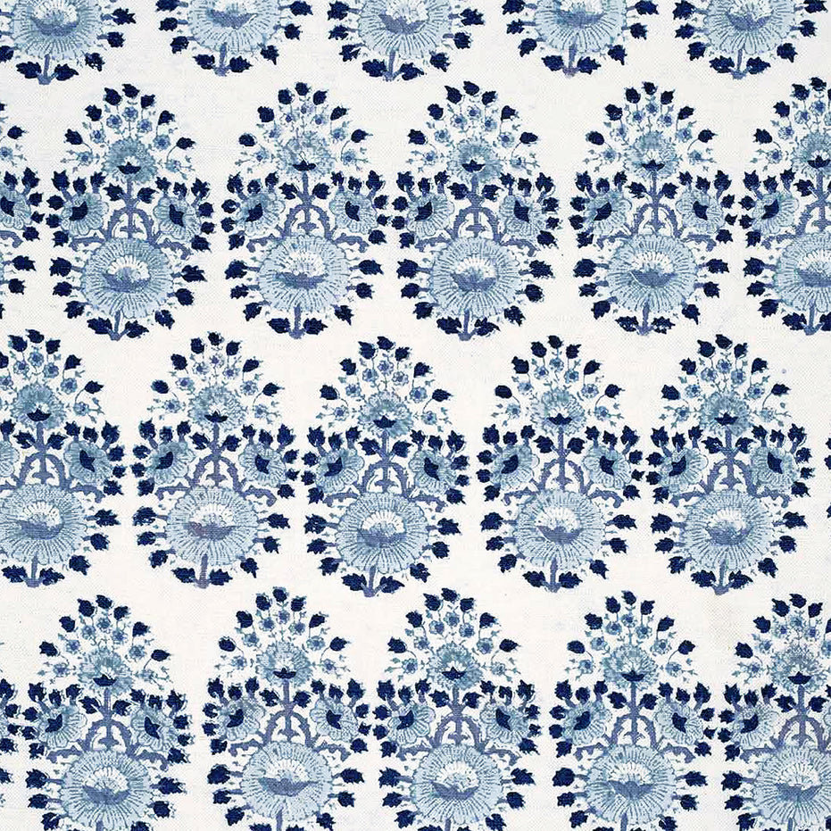 A blue and white floral pattern on a white background, created through traditional craftsmanship using Lanka Lapis Fabric by John Robshaw.