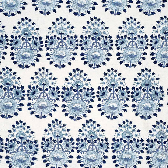 A blue and white floral pattern on a white background, created through traditional craftsmanship using Lanka Lapis Fabric by John Robshaw.