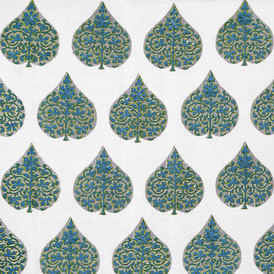 A hand block printed Ratana Peacock fabric in blue and green leaf pattern on a white linen/cotton blend fabric, showcasing traditional craftsmanship by John Robshaw.