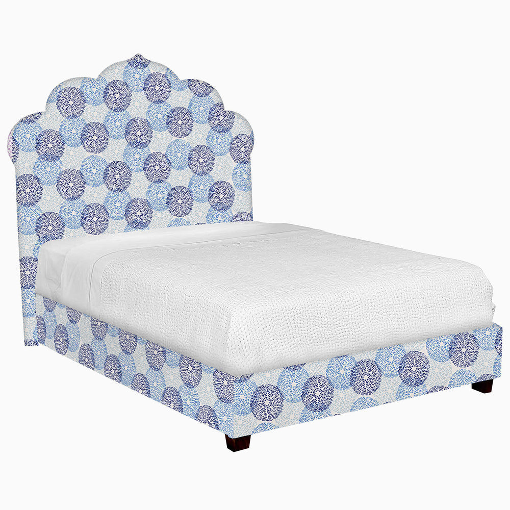 A John Robshaw Custom Bihar Bed with a blue and white patterned fabric.
