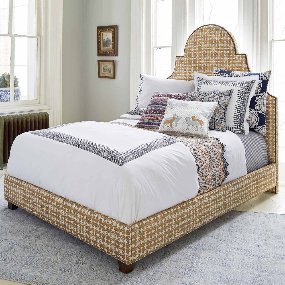 A Custom Dara Bed in a bedroom with white glove delivery and a blue and white comforter. (Brand Name: John Robshaw)