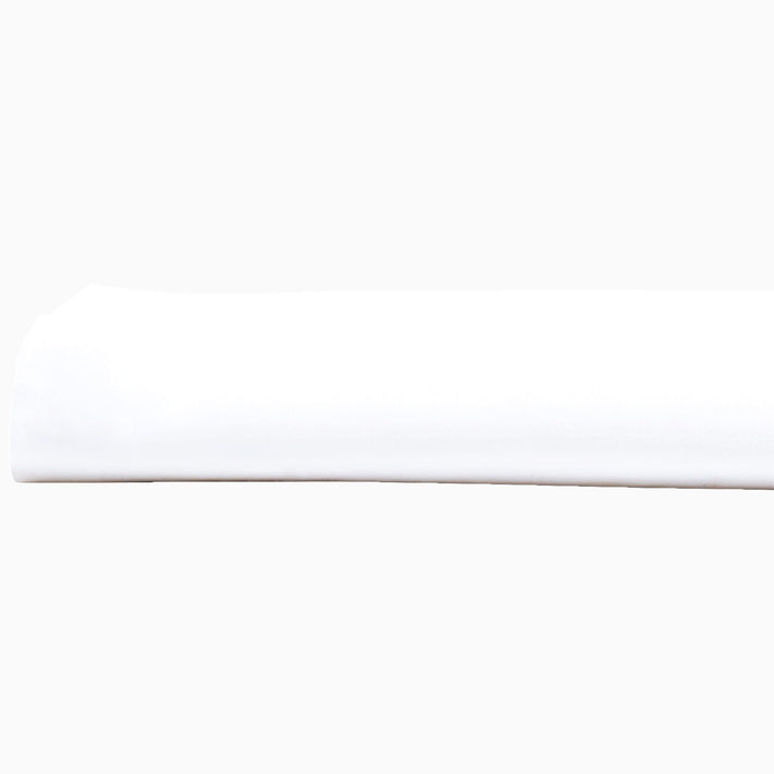 A John Robshaw Organic White Fitted Sheet, made of organic cotton, lying on top of a white surface in India.