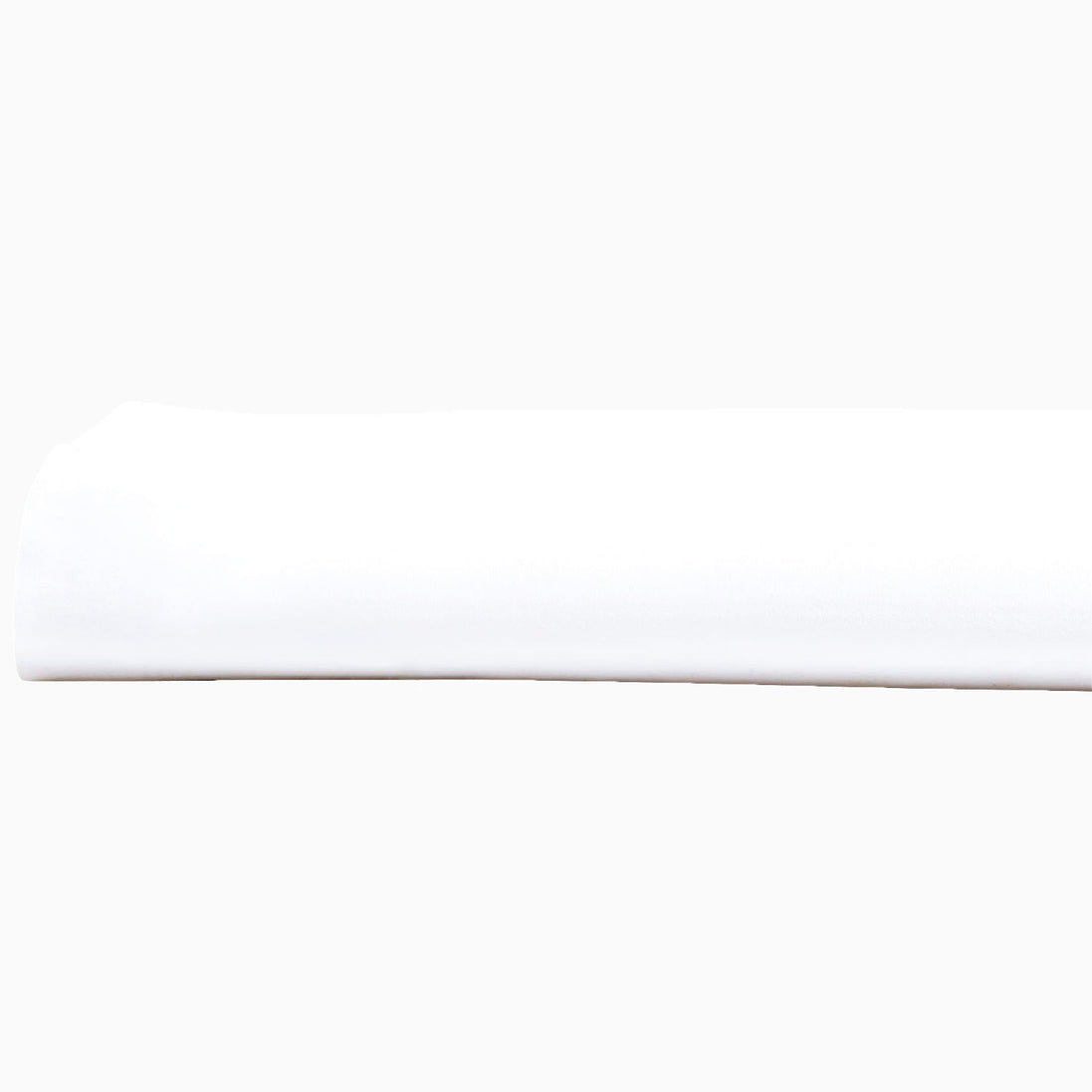 A John Robshaw Organic White Fitted Sheet, made of organic cotton, lying on top of a white surface in India.