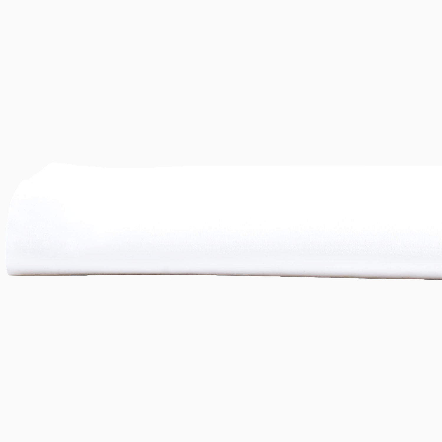A John Robshaw Organic White Fitted Sheet, made of organic cotton, lying on top of a white surface in India.